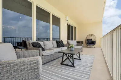 a living room with a couch and a table at Newly Renovated Luxury OCEAN FRONT Condo! Top Floor Condo with PENTHOUSE OCEAN VIEWS! in Panama City Beach