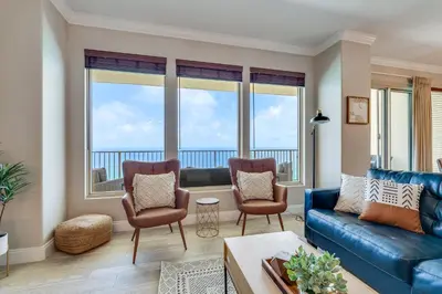 a living room with a couch and two chairs at Newly Renovated Luxury OCEAN FRONT Condo! Top Floor Condo with PENTHOUSE OCEAN VIEWS! in Panama City Beach