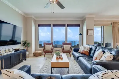 a living room with a couch and a table at Newly Renovated Luxury OCEAN FRONT Condo! Top Floor Condo with PENTHOUSE OCEAN VIEWS! in Panama City Beach