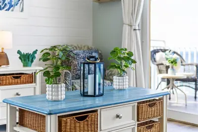 a blue table with two potted plants on it at Coral Charm in Panama City Beach