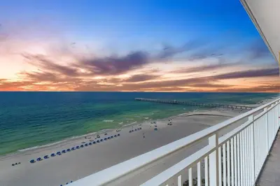 a view of the beach and the ocean from a balcony at Coral Charm in Panama City Beach
