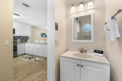 a bathroom with a sink and a mirror at Gulf Highlands #175 by Nautical Properties in Panama City Beach