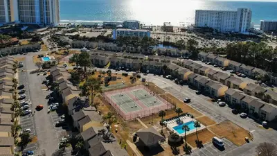 an aerial view of a city with a tennis court at Gulf Highlands #175 by Nautical Properties in Panama City Beach