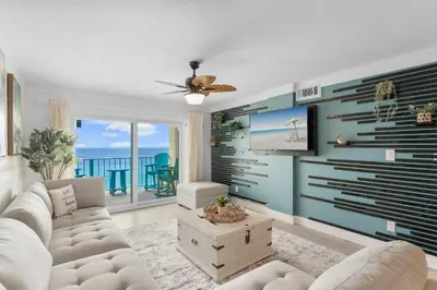 a living room with a couch and a view of the ocean at Deep Savings While Regency Updates Oct-March in Panama City Beach