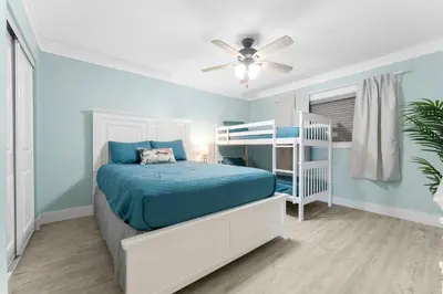 a bedroom with a bed and a ceiling fan at Deep Savings While Regency Updates Oct-March in Panama City Beach