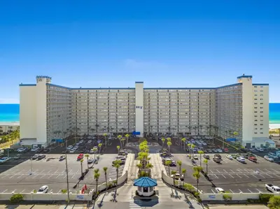 a large building with cars parked in a parking lot at Deep Savings While Regency Updates Oct-March in Panama City Beach