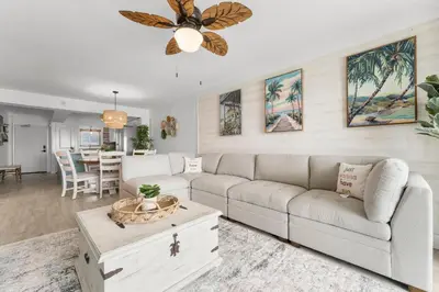 a living room with a couch and a ceiling fan at Deep Savings While Regency Updates Oct-March in Panama City Beach