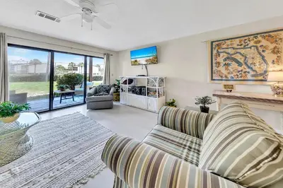 a living room with a couch and a fireplace at Portside P1 in Panama City Beach