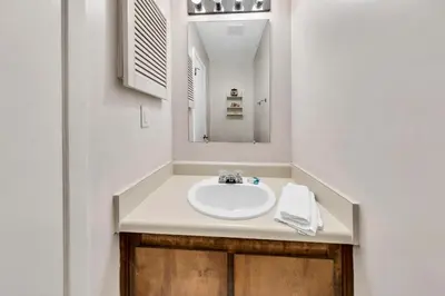 a bathroom with a sink and a mirror at Portside P1 in Panama City Beach