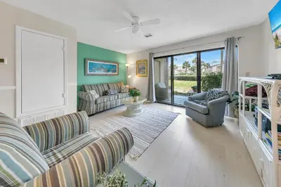 a living room with a couch and a chair at Portside P1 in Panama City Beach