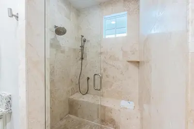 a bathroom with a shower with a glass door at Plimsoll Retreat at Watersound West Beach in Santa Rosa Beach