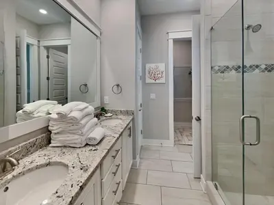 a white bathroom with a sink and a shower at Prominence North #54A - Barefoot Bungalow in Inlet Beach