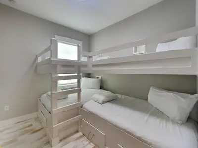 a small bedroom with bunk beds and a window at Prominence North #54A - Barefoot Bungalow in Inlet Beach