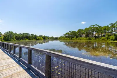 a view of a river from a wooden bridge at Prominence North #54A - Barefoot Bungalow in Inlet Beach