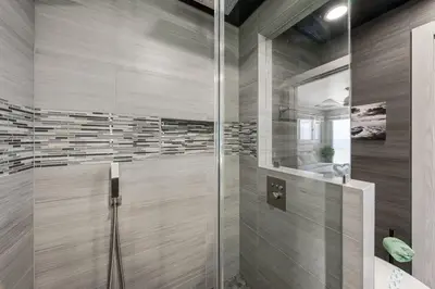 a bathroom with a shower with a glass door at The Summit 1001 in Panama City Beach