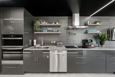 a kitchen with gray cabinets and a sink and a stove at The Summit 1001 in Panama City Beach