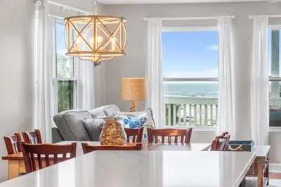a dining room with a view of the ocean at Serenity - Inlet Beach in Inlet Beach