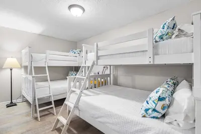 a bedroom with two bunk beds and a lamp at Serenity - Inlet Beach in Inlet Beach