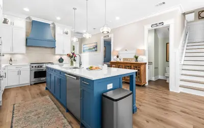 a kitchen with blue cabinets and a blue island at Sea Power in Santa Rosa Beach