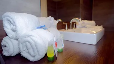 a bathroom with towels on a counter and a sink at Banana Peel Lodge in Panama City Beach