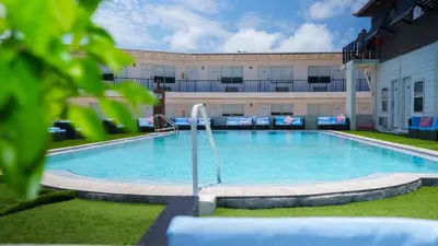 a large swimming pool in front of a building at Banana Peel Lodge in Panama City Beach