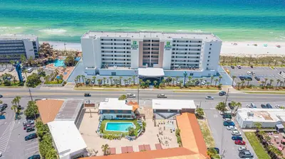 an aerial view of a hotel and the beach at Banana Peel Lodge in Panama City Beach