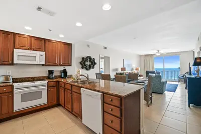 a kitchen and living room with a view of the ocean at 607-E-Splash in Panama City Beach