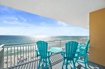 two chairs and a table on a balcony with the ocean at 607-E-Splash in Panama City Beach