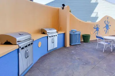 a patio with two stoves and a table and chairs at 607-E-Splash in Panama City Beach