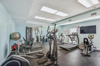 a gym with several cardio machines in a room at 909-Seychelles in Panama City Beach