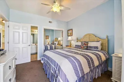 a bedroom with a bed and a ceiling fan at 909-Seychelles in Panama City Beach