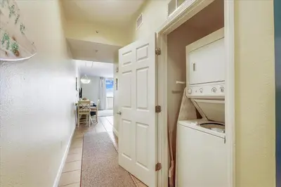 a kitchen with a white door and a white dishwasher at 804-Tidewater in Panama City Beach
