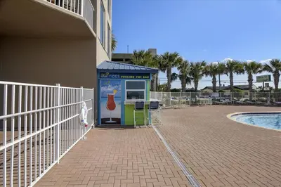 a small kiosk next to a swimming pool at 804-Tidewater in Panama City Beach