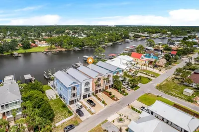 an aerial view of a town with a river at Beach Bay Getaway! Bayfront 4BR 4BA House Sleeps 12 Private pool Boat dock in Panama City Beach
