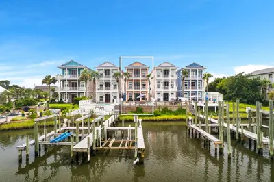 a large house on the water with a dock at Beach Bay Getaway! Bayfront 4BR 4BA House Sleeps 12 Private pool Boat dock in Panama City Beach