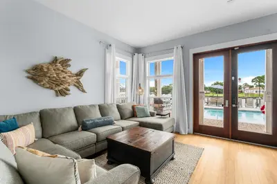a living room with a couch and a table at Beach Bay Getaway! Bayfront 4BR 4BA House Sleeps 12 Private pool Boat dock in Panama City Beach