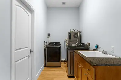 a kitchen with a stove and a sink next to a door at Beach Bay Getaway! Bayfront 4BR 4BA House Sleeps 12 Private pool Boat dock in Panama City Beach