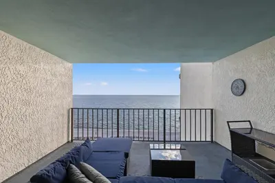 a living room with a couch and a view of the ocean at Watercrest 906 | Sand, Sea & Serenity in Panama City Beach