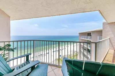 a balcony with chairs and a view of the ocean at Dunes of Panama 2104E in Panama City Beach
