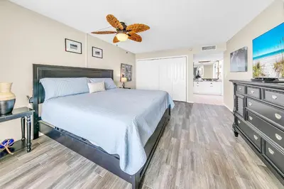 a bedroom with a bed and a ceiling fan at Dunes of Panama 2104E in Panama City Beach