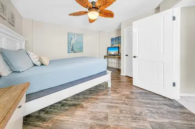 a bedroom with a bed and a ceiling fan at Dunes of Panama 2104E in Panama City Beach
