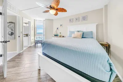 a bedroom with a bed and a ceiling fan at Dunes of Panama 2104E in Panama City Beach