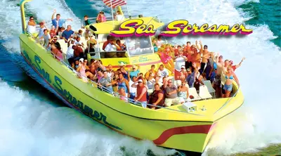 a group of people riding a banana boat in the water at Sea Breeze House- 3 bd 2 ba 5 min walk to beach in Panama City Beach