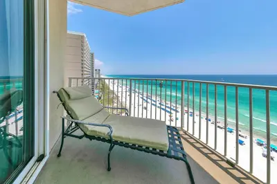 a bench on a balcony with a view of the ocean at Grandview East 1201 in Panama City Beach