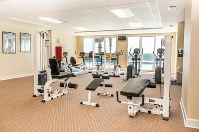 a fitness room with treadmills and tread machines at Sunrise Beach #2107 in Panama City Beach