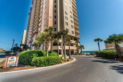 an empty street in front of a building with palm trees at Sunrise Beach #2107 in Panama City Beach