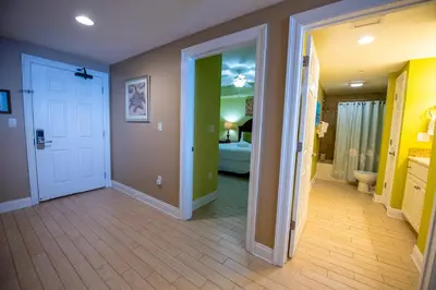 a hallway with a door open to a bedroom at Treasure Island 1910 in Panama City Beach