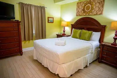 a bedroom with a large bed and a television at Treasure Island 1910 in Panama City Beach