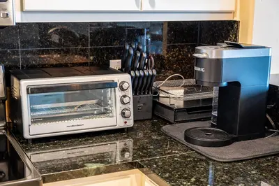 a kitchen counter with a toaster oven and a coffee maker at Treasure Island 1910 in Panama City Beach