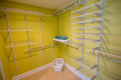 a walk in closet with shelves and a yellow wall at Treasure Island 1910 in Panama City Beach